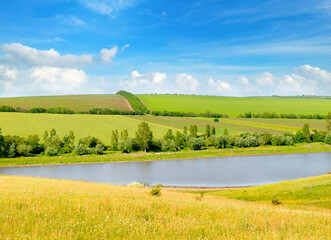 Agricultural fields, meadows, lake and sky. - 794161340