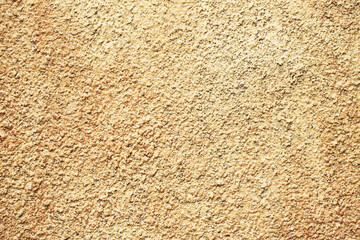 Yellow paint stucco wall texture. Concrete surface background. Color plaster wall pattern. Artistic smudges of plaster on the wall. Decorative wall paint technique.
