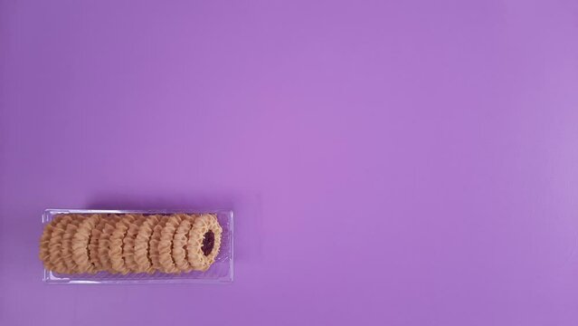 Stack of cookies in box. Stop motion film clip. package is filled with round Sugar cookies. cake sort from least to greatest