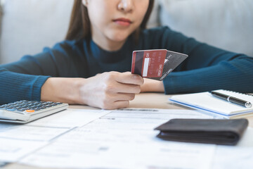 Business financial concept, stressed asian young business woman hand holding credit card for...