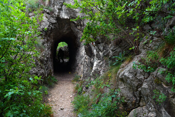 Stone carved tunnel in Nerei Gorges Natural Park, Romania, Europe