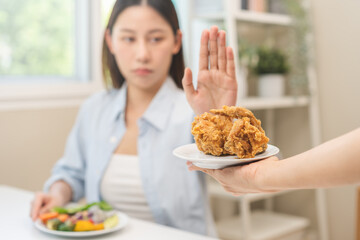 Diet, Dieting asian young woman hand push out, reject fried chicken on plate, deny to eat fast,...