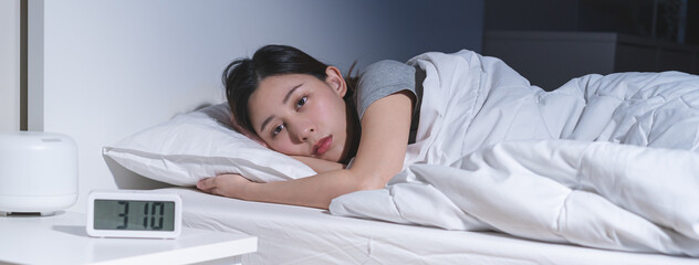 Annoyed, stressed, anxiety asian young woman suffering from insomnia, frustrated awake on bed at...
