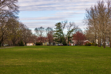 A beautiful spring view of one of the streets in New Jersey, lined with villas adjacent to a park...