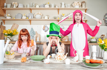Funny crazy friends having fun and fool around with mad tea party concept