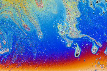 Colorful liquid mixture, blending paints in dynamic abstract fluid texture background, close up shot. Artistic, surreal and psychedelic design concept.