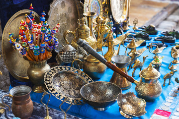 Assortment of a street bazaar in Bukhara. Dishes made of brass - obrazy, fototapety, plakaty