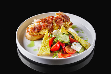 toast with scramble and bacon on a white plate