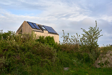 Environmentally friendly eco house with solar cells and photovoltaic. Sustainable vacation home in...