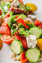 salad with baked bell peppers tomatoes cucumber red onion and feta cheese