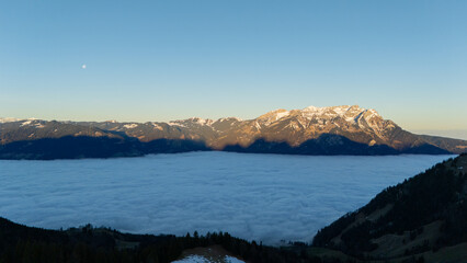 Autumnal and morning view of sea of clouds on maple trees and peak of Mount Pilatus in Lucern,...
