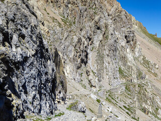 Scenic hiking traila along the ridge of Monte Oserot near rifugio della Gardetta on Italy French border in Maira valley in Cottian Alps, Piedmont, Italy, Europe. Hike on alpine rocky terrain in summer
