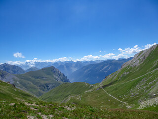 Obraz premium Scenic view from Monte Oserot near rifugio della Gardetta on Italy French border in Maira valley in Cottian Alps, Piedmont, Italy, Europe. Hiking on alpine pasture on sunny summer day in mountains