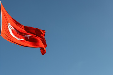A Turkish flag flying from a pole.