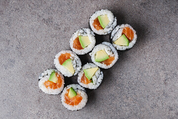 delicious fresh futomaki sushi roll with salmon and avocado