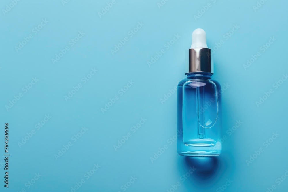 Poster blue liquid bottle on blue surface. suitable for science or laboratory concepts