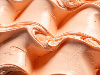 Frozen orange flavour gelato - full frame detail. Close up of a orange color surface texture of Ice cream.