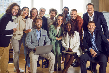 Portrait of large group of diverse business people working together on joint project. Cheerful...