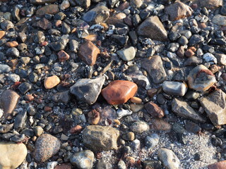 The beach with the colorful stone field in Prora is a beautiful and tranquil photo motif, perfect for use as texture or background