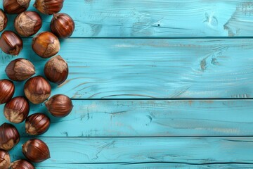 Fresh hazel nuts arranged on a blue wooden table. Perfect for food and nutrition concepts - obrazy, fototapety, plakaty