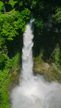 River landscape waterfall with green forest in Lake Sebu. Hikong Bente Falls in Slow motion. Mindanao, Philippines.