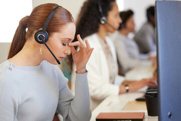 Portrait, woman and headphone with headache at work for call center or customer care in office with...