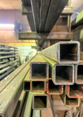 Steel tubes stacked in a machine shop with bokeh