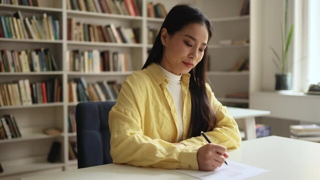 Portrait of worried young asian woman student working on difficult test which did not prepare at university class Upset girl feeling nervous during exams with hard program indoors
