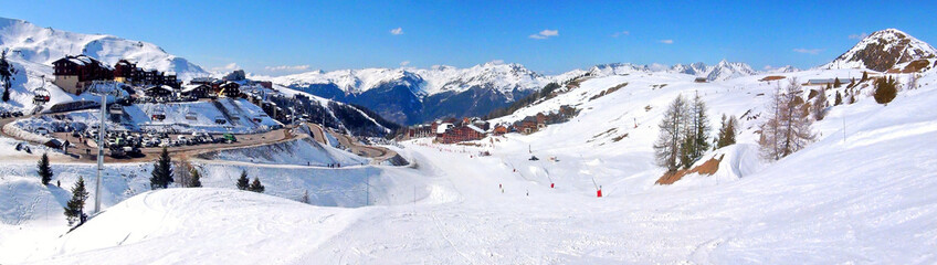 Panoramic view of the ski slopes of the famous La Plagne-village ski resort in the heart of the French Alps in the Tarentaise valley at the foot of Mont Blanc