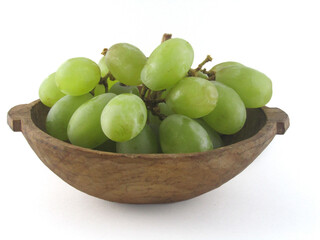 green grape in natural wooden bowl white background