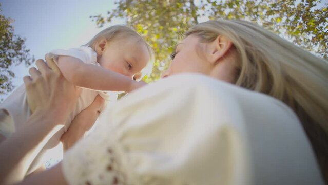 Beautiful Blonde mom and cute baby boy family fun outdoor