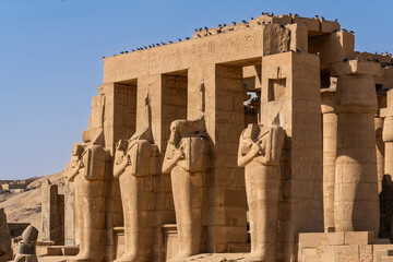 Luxor, Egypt: Exterior view of the famous Ramesseum, the memorial temple of Pharaoh Ramesses II in the Luxor westbank in Upper Egypt without any tourists around. - obrazy, fototapety, plakaty