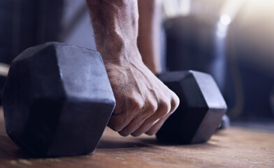 Man, dumbbell and hand in gym for training, fitness or exercise to gain muscle for health, strength...