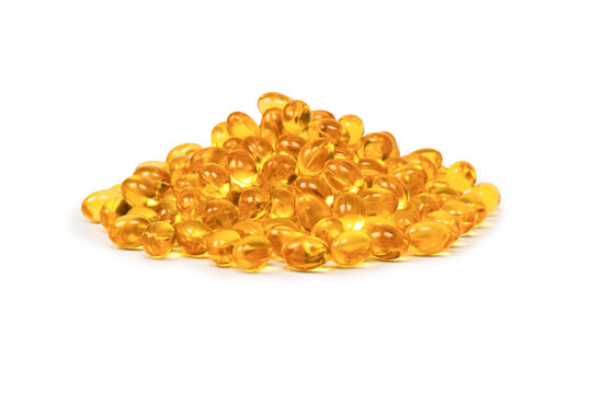 A group of yellow capsules isolated on a white background.