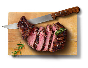 Flavored rib eye beef sliced on wooden cutting board with knife