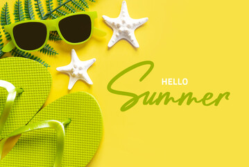 Hello Summer. Flat lay composition with sunglasses, starfish, seashells and beach flip flops with text Hello Summer