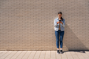 Beautiful woman writing a message with her cell phone