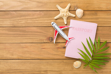 Bright flat lay with travel accessories on wooden background, top view