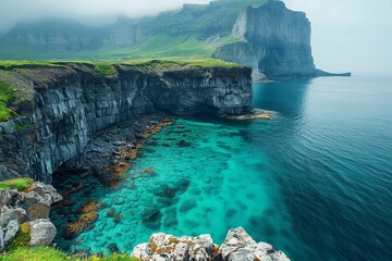 A breathtaking coastal scenery: turquoise waters, rocky cliffs, and green grass under a blue sky. - Powered by Adobe