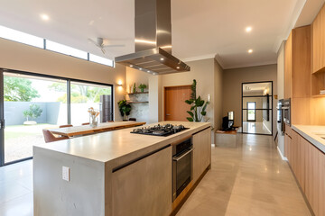 Contemporary modern kitchen interior in beige colors and concrete elements.