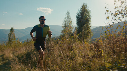 Wild nature recreation mountain scene. Fit Caucasian male man guy sprinter run sprinting running...