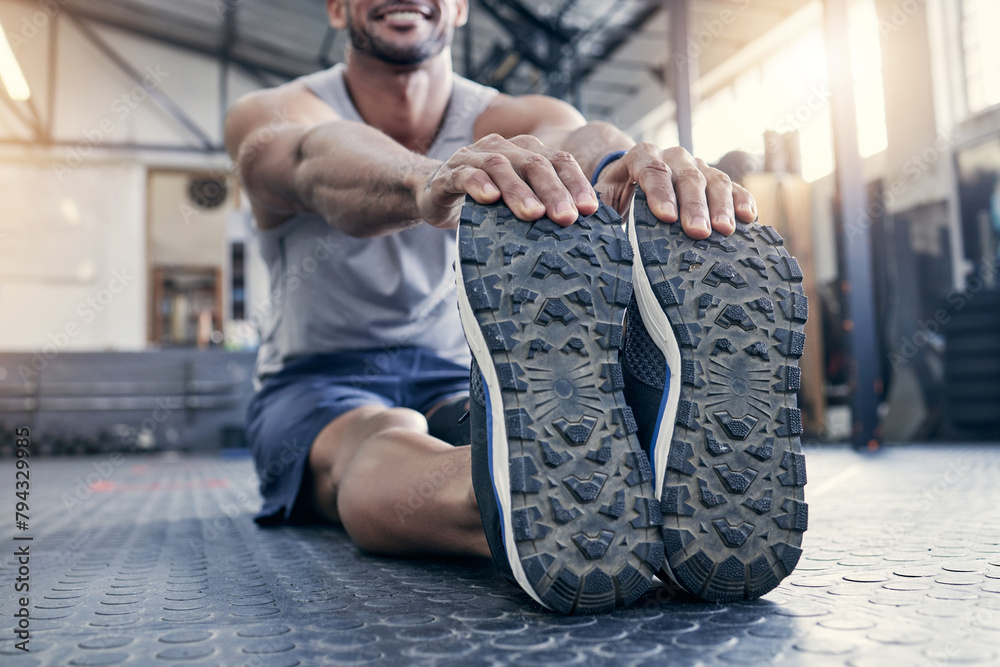 Poster Fitness, feet and man with stretching at gym for exercise, preparation and performance on floor. Health club, training and legs of male person with warm up for flexibility, workout and cardio energy