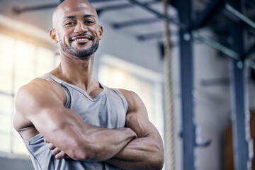Man, portrait and arms crossed in gym for exercise with smile, training or workout for fitness....