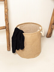 Jute basket for storing laundry, clothes, toys. Black towel in basket
