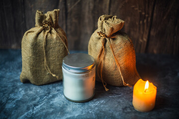 Subject photography - pouches and a container jar in the light of a candle
