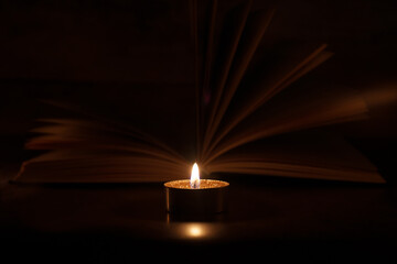 The Book in the candlelight