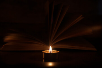 The Book in the candlelight