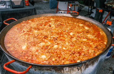 Paella Cooks in Large Pan at a Food Booth at the Freret Street Festival in New Orleans, Louisiana,...