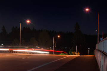 Traffic blur on rural overpass on dark night