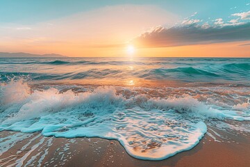 Sunset over the ocean with waves crashing onto the shore under a clear sky.
